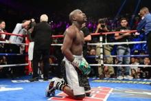 Floyd Mayweather kneels after the final round against Andre Berto (not pictured) in their WBA/WBC welterweight title bout at MGM Grand Garden Arena. Mayweather won via unanimous decision September 13, 2015. PHOTO BY USA TODAY Sports/Joe Camporeale