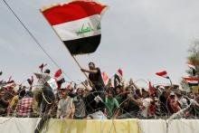 Followers of Iraq's Shi'ite cleric Moqtada al-Sadr chant slogans during a protest demanding that parliament approves a long-delayed new cabinet and end political and sectarian wrangling that is hampering a vote on the matter in the streets outside Baghdad's heavily fortified Green Zone in Iraq, April 26, 2016. PHOTO BY REUTERS/Ahmed Saad