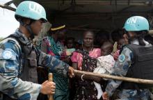 United Nations peacekeepers control South Sudanese women and children before the distribution of emergency food supplies at the United Nations protection of civilians (POC) site 3 hosting about 30,000 people displaced during the recent fighting in Juba, South Sudan, July 25, 2016. PHOTO BY REUTERS/Adriane Ohanesian