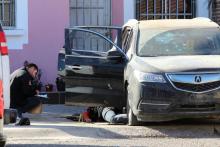 A forensic technician takes notes next to the body of an unknown assailant killed during a shooting with Mexican marines in Culiacan, Mexico, February 7, 2017. PHOTO BY REUTERS/Jesus Bustamante