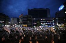 Participants holding funeral streamers bearing messages for victims of the capsized passenger ship Sewol, march during a lotus lantern parade to celebrate the upcoming birthday of Buddha and to commemorate the victims, in Seoul