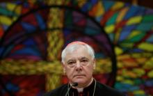 Newly elected cardinal Gerhard Ludwig Muller of Germany smiles as he holds a news conference to unveil his book "Poor for the Poor: The Mission of the Church", with the preface written by Pope Francis, in downtown Rome, Italy, February 25, 2014. PHOTO BY REUTERS/Max Rossi