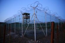 Chain link fence and concertina wire surrounds a deserted guard tower within Joint Task Force Guantanamo's Camp Delta at the U.S. Naval Base in Guantanamo Bay, Cuba, March 21, 2016. PHOTO BY REUTERS/Lucas Jackson