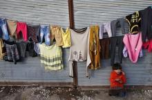 A Kurdish refugee girl from the Syrian town of Kobani sits at a refugee camp in the Turkish border town of Suruc, Sanliurfa province, February 2, 2015. PHOTO BY REUTERS/Umit Bektas