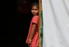 A Syrian refugee girl stands at the entrance of her tent at a camp for Syrian refugees near the town of Qab Elias, in Lebanon's Bekaa Valley, August 8, 2017. PHOTO BY REUTERS/Jamal Saidi