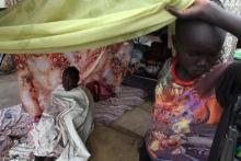 A girl with measles sits under a tent at Tomping camp in Juba, where some 17,000 displaced people who fled their homes are sheltered by the United Nations, January 10, 2014. PHOTO BY REUTERS/Andreea Campeanu