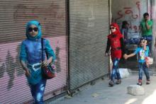 Girls walk along a street on the first day of the Muslim holiday of Eid al-Fitr, which marks the end of the holy month of Ramadan, in a rebel-held area of Aleppo, Syria, July 17, 2015. PHOTO BY REUTERS/Abdalrhman Ismail