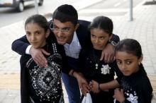 Yemenite Jewish girls, some of 19 Jews from Yemen, who were brought to Israel by the quasi-governmental Jewish Agency for Israel are greeted by their relative, Zion Dahari, at an absorption center in Beersheba, Israel, March 21, 2016. PHOTO BY REUTERS/Baz Ratner
