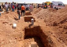 Three graves that were dug for the two Syrian toddlers and their mother, all of whom drowned as they were trying to reach Greece, are pictured during their funeral in the Syrian border town of Kobani, September 4, 2015. PHOTO BY REUTERS/Rodi Said