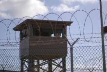 A soldier stands guard in a tower overlooking Camp Delta at Guantanamo Bay naval base in a December 31, 2009 file photo provided by the US Navy. PHOTO BY REUTERS/Spc. Cody Black