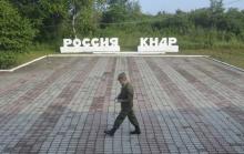 A guard walks along the platform at the border crossing between Russia and North Korea at the North Korean settlement of Tumangan July 18, 2014. The signage reads, "Russia" and "KNDR (Democratic People's Republic of Korea)". PHOTO BY REUTERS/Yuri Maltsev