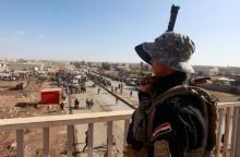 A member of Iraqi security forces stands guard during an operation against Islamic State militants in Mosul, Iraq, December 3, 2016. PHOTO BY REUTERS/Alaa Al-Marjani