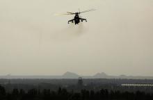 A Ukrainian Mi-24 gunship manoeuvres over a residential area near Donetsk international airport