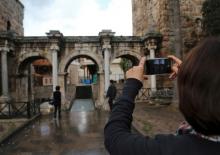 A tourist takes a picture of the Hadrian's Gate, a triumphal arch in the Mediterranean resort city of Antalya, a popular destination for German tourists in Turkey, January 13, 2016. PHOTO BY REUTERS/Kaan Soyturk