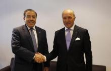 Tunisia's Foreign Minister Mongi Hamdi (L) shakes hands with his French counterpart Laurent Fabius at the Tunis-Carthage International Airport in Tunis, September 7, 2014. PHOTO BY REUTERS/Zoubeir Souissi