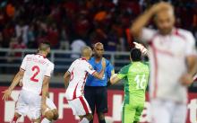 Tunisia's Hamza Mathlouthi and his team mates react after referee Rajindraparsad Seechurn (3rd L) awarded a penalty at the last minute to Equitorial Guinea during their quarter-final soccer match of the 2015 African Cup of Nations in Bata, January 31, 2015. PHOTO BY REUTERS/Amr Abdallah Dalsh