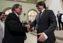 Catalan regional President Carles Puigdemont (R) greets former president Artur Mas after the regional parliament voted to hold a referendum on independence from Spain in the Catalonian regional Parliament in Barcelona, Spain, September 7, 2017. PHOTO BY REUTERS/Albert Gea