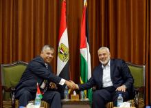 Palestinian Hamas Chief Ismail Haniyeh shakes hands with Egyptian intelligence chief Khaled Fawzi in Gaza City, October 3, 2017. PHOTO BY REUTERS/Mohammed Salem