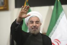 Hassan Rohani gestures to the media during a news conference in Tehran