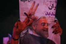 A supporter of Iranian president Hassan Rouhani holds his poster as she celebrates his victory in the presidential election, in Tehran, Iran, May 20, 2017. PHOTO BY REUTERS/TIMA