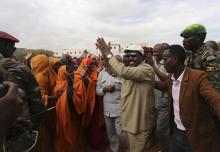 Somalia's President Hassan Sheikh Mohamud waves to residents upon arrival at Barawe, a port town recaptured from the militant al Shabaab insurgents, south of the capital Mogadishu