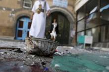 People walk past a headgear lying on the ground at the al-Balili mosque after two bombings at the mosque in Yemen's capital Sanaa, September 24, 2015. PHOTO BY REUTERS/Khaled Abdullah