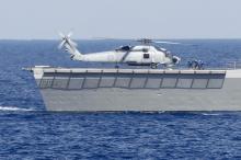 Taiwan navy soldiers run to a S-70C helicopter after it landed on a Taiwan naval Lafayette-class frigate during a joint military drill outside a navy base in Kaohsiung port, southern Taiwan