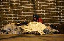 A homeless woman is seen on a cold winter night near Beijing South Railway Station in Beijing, China, January 23, 2016. PHOTO BY REUTERS/Jason Lee
