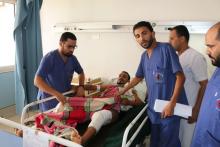 A man (C) lies in a bed at Sbaah hospital, after he was injured in a shelling in Qaser Bin Ghashir, near the Tripoli International Airport, July 26, 2014. PHOTO BY REUTERS/Hani Amara