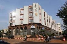 People drive motorcycles past the Radisson Blu hotel in Bamako, Mali, November 22, 2015. PHOTO BY REUTERS/Joe Penney