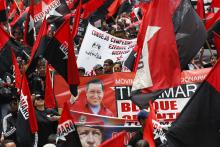 Members of the Revolutionary Movement Tupamaro hold giant pictures of late Venezuelan President Hugo Chavez, as they take part in a rally in support of Venezuelan President Nicolas Maduro's government, in Caracas