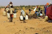 People walk to fill water containers at the Zamzam IDP camp for Internally Displaced Persons (IDP), near El Fasher in North Darfur, February 4, 2015. PHOTO BY REUTERS/ Mohamed Nureldin Abdallah