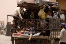 Internally displaced people who fled Raqqa city ride a vehicle with their belongings in a camp near Ain Issa, Raqqa Governorate, Syria, May 19, 2017. PHOTO BY REUTERS/Rodi Said