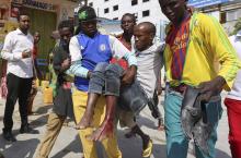 Residents evacuate a civilian injured in a car bomb explosion near the Taleex junction of Somalia's capital Mogadishu, January 2, 2015. PHOTO BY REUTERS/Feisal Omar