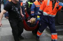 An injured person is helped by emergency services outside Sennaya Ploshchad metro station, following explosions in two train carriages at metro stations in St. Petersburg. PHOTO BY REUTERS/Anton Vaganov