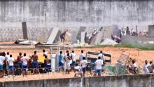 Inmates from different gangs (top and bottom) protect themselves during an uprising at Alcacuz prison in Natal, Rio Grande do Norte state, Brazil, January 17, 2017. PHOTO BY REUTERS/Josemar Goncalves