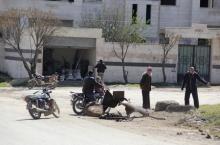 People inspect a site targeted by what activists said was a poison gas attack in the village of Sarmin in Idlib province, March 17, 2015. PHOTO BY REUTERS/Mohamad Bayoush