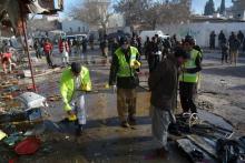 Crime scene investigators collect evidence from the site of a suicide bomb attack close to a polio eradication centre in Quetta, Pakistan, January 13, 2016. PHOTO BY REUTERS/Stringer