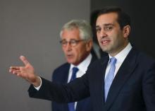 Georgia's Defence Minister Irakly Alasania (R) and U.S. Defense Secretary Chuck Hagel walk before a news conference in Tbilisi