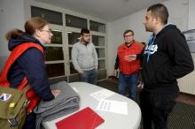 Iraqi asylum seekers speak to Finnish Red Cross workers in a refugee center in Lahti, Finland, September 25, 2015. PHOTO BY REUTERS/Markku Ulander