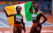 Ivory Coast's Murielle Ahoure celebrates winning the Women's 60m Final with runner up Ivory Coast's Marie-Josee Ta Lou. PHOTO BY REUTERS/John Sibley