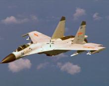 File photo of a Chinese J-11 fighter jet seen flying near a U.S. Navy P-8 Poseidon about 215 km (135 miles) east of China's Hainan Island, August 19, 2014. PHOTO BY REUTERS/U.S. Navy