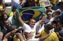 Congressman Jair Bolsonaro holds a Brazilian flag during a protest against Brazil's President Dilma Rousseff, part of nationwide protests calling for her impeachment, in Brasilia, Brazil, March 13, 2016. PHOTO BY REUTERS/Ueslei Marcelino