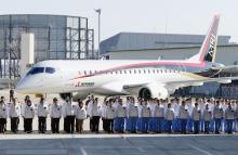A Mitsubishi Regional Jet (MRJ) is unveiled at the hanger for its roll out ceremony at Mitsubishi Heavy Industries' Nagoya Aerospace Systems Works Komaki Minami Plant in Toyoyama town, Nagoya prefecture