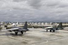 Russian and Syrian servicemen line up near military jets during a ceremony dedicated to the withdrawal of Russian troops from Syria at Hmeymim airbase, Syria, March 15, 2016. PHOTO BY REUTERS/Vadim Grishankin
