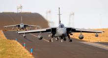 Royal Air Force Tornado jet aircraft taxi on the runway before taking off from RAF Lossiemouth airbase in Moray, northern Scotland, March 1, 2011. PHOTO BY REUTERS/David Moir