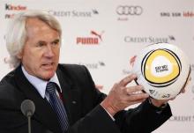 Jiri Dvorak, Chief Medical Officer of the FIFA presents a ball with the lettering "SAY NO! TO DOPING" during a news conference at the training camp of Switzerland's national soccer team in Crans Montana