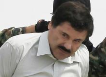 Joaquin "El Chapo" Guzman is escorted by soldiers during a presentation at the Navy's airstrip in Mexico City, February 22, 2014. REUTERS/Henry Romero
