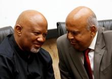South Africa's outgoing Finance Minister Pravin Gordhan (R) chats with Deputy Minister Mcebisi Jonas during a media briefing at their offices in Pretoria, South Africa, March 31,2017. PHOTO BY REUTERS/Siphiwe Sibeko