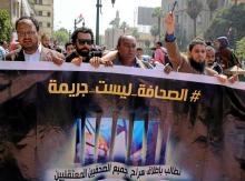 Egyptian journalists hold a banner outside the Egyptian Press Syndicate in downtown Cairo, Egypt, April 28, 2016. The banner reads "Press is not a crime." PHOTO BY REUTERS REUTERS/Mohamed Abd El Ghany